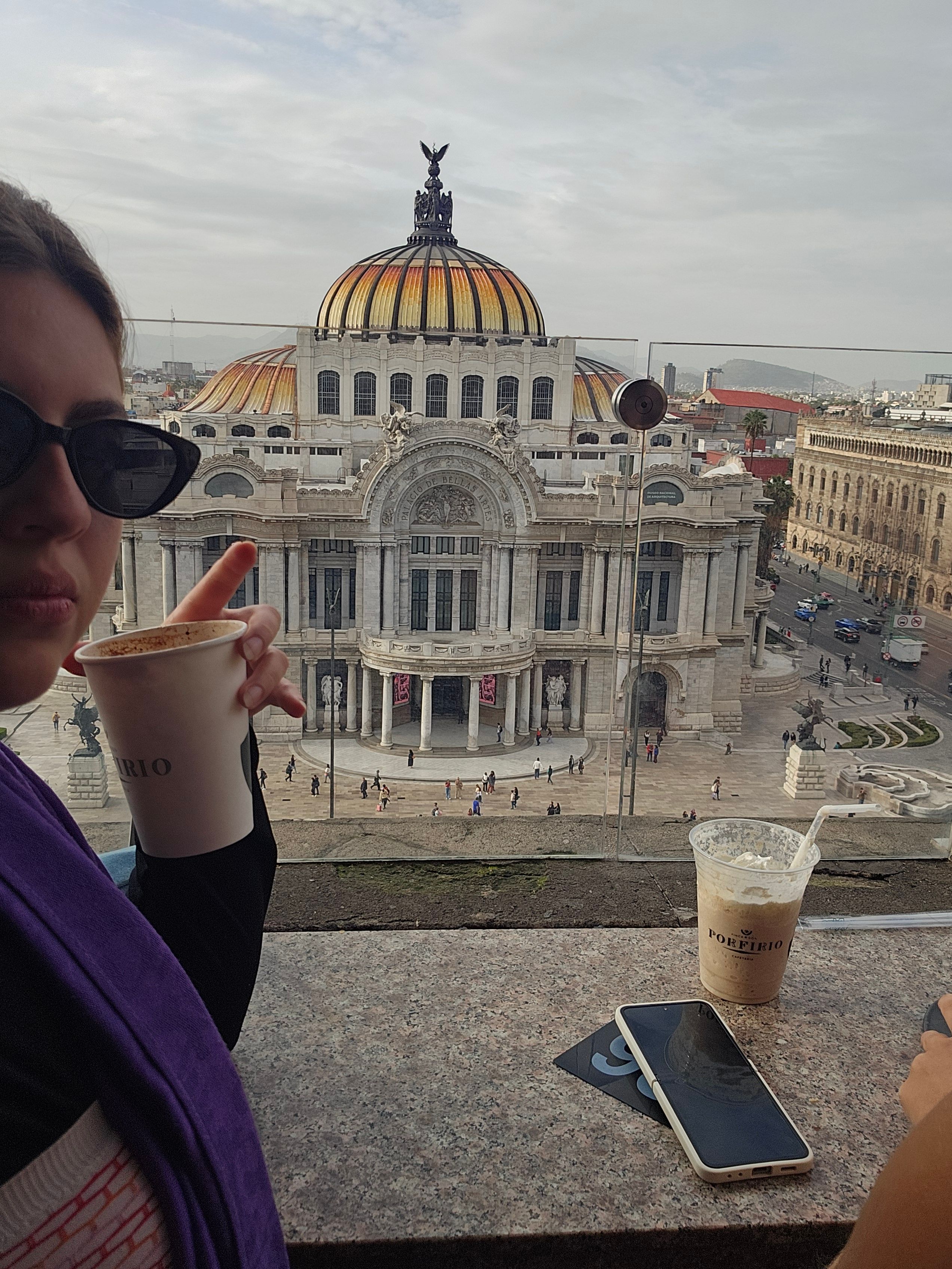 Coffee in hand, looking out over a city square
